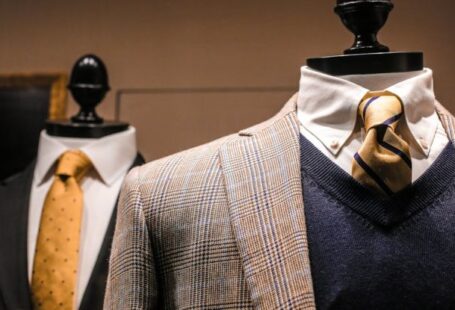 Exclusive Boutiques - Dandy fancy jackets with shiny ties on dummies in showroom of contemporary male shop