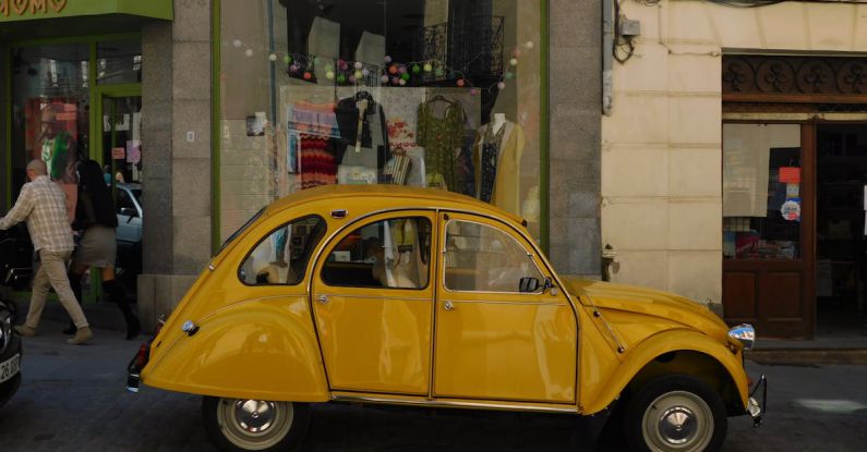 Shopping Districts - Yellow Vintage Car on a Street
